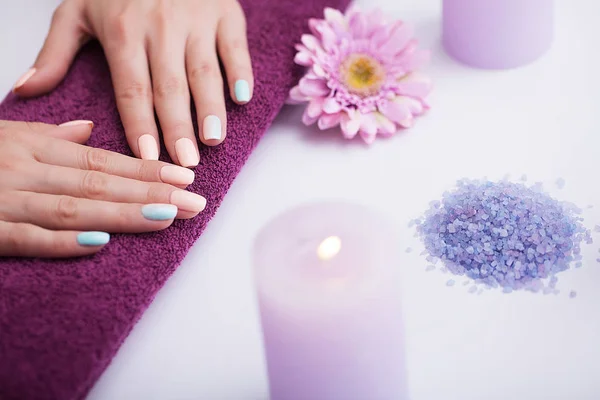Spa Nail Procedures. Beautiful manicure on the hands. Beautiful hands after a spa treatment. The concept of spa and beauty.