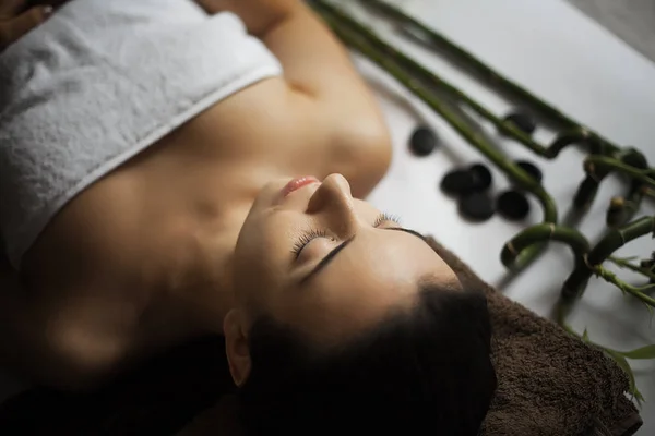 Picture of woman in spa salon lying on the massage desk — Stock Photo, Image