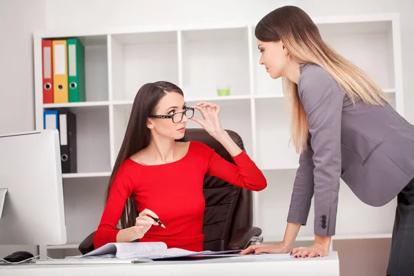 Two businesswomen working together.Girl is sitting at table in f — Stock Photo, Image