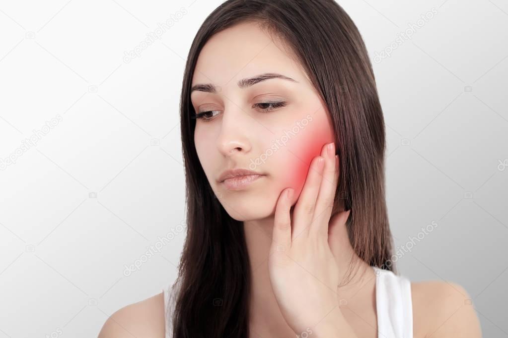 Woman In Pain. Closeup Of Beautiful Young Woman Feeling Painful Toothache, Touching Face With Hand. Sad Stressed Girl Feeling Strong Teeth, Jaw Or Neck Pain. Dental Health And Care. High Resolution