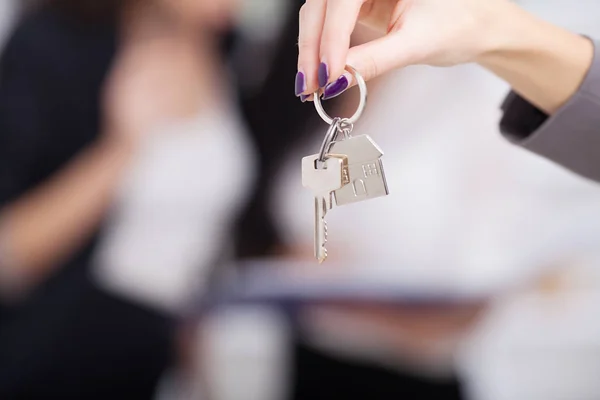 Real estate agent giving house keys to a customer Stock Image