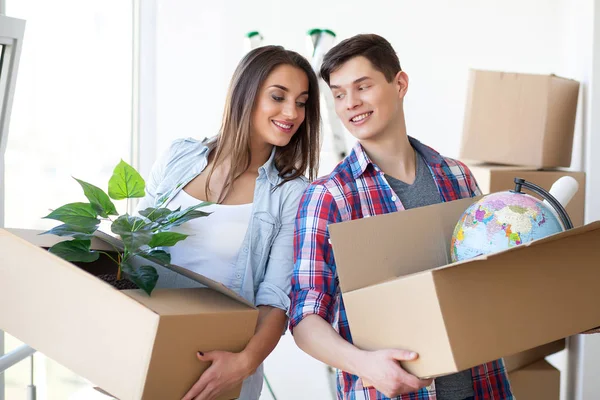 Een paar met dozen wordt verplaatst naar een nieuw huis. Onroerend goed te koop. — Stockfoto