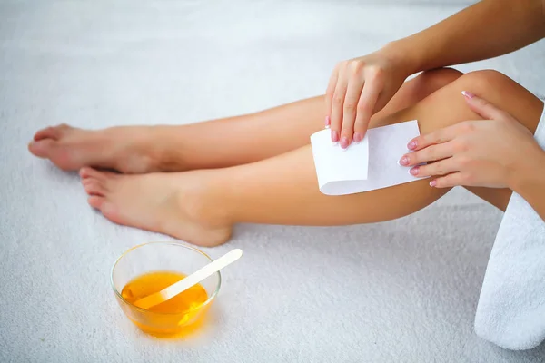 Waxing. Depilation legs with waxing and tape — Stock Photo, Image