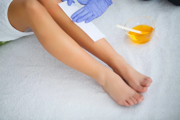 Waxing. Beautician Waxing Woman\'s Leg In Spa Salon