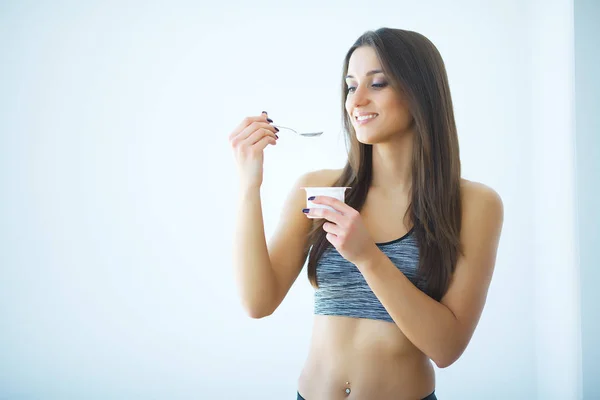 Δίαιτα. Ευτυχισμένη γυναίκα τρώει γιαούρτι στην κουζίνα — Φωτογραφία Αρχείου