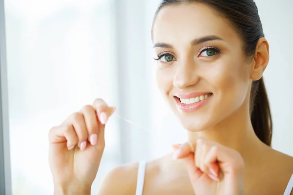 Cuidados dentários. Mulher com sorriso bonito usando o Floss para dentes. H — Fotografia de Stock