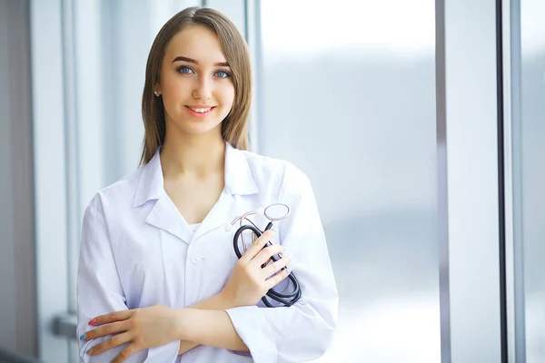 Cute brunette in medical gown and a stethoscope in an hospital — Stock Photo, Image