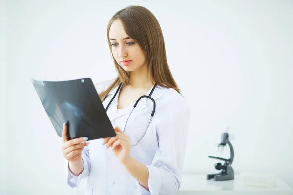 Concerned male doctor looking at x-ray — Stock Photo, Image