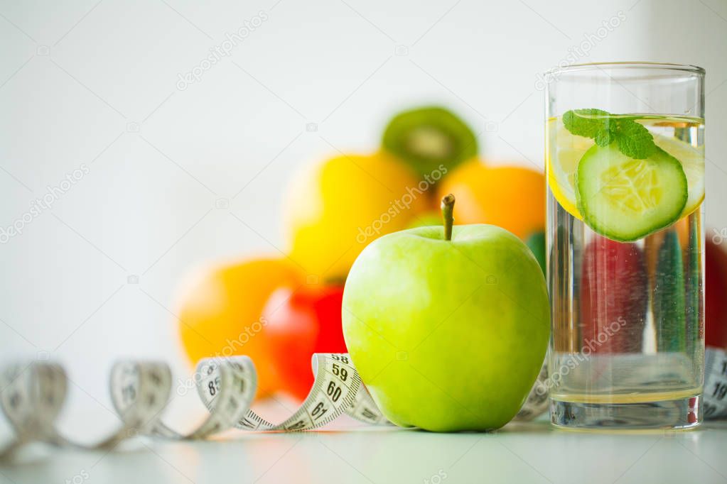 Green apples, glass water with mint leaves, lemon and cucumber, 