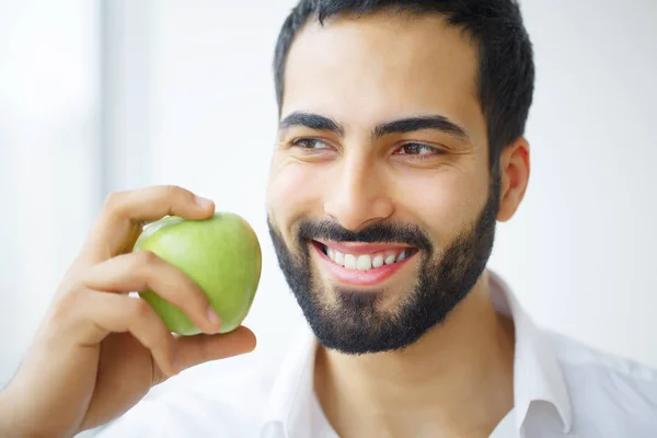 Man Eating Apple. Beautiful Girl With White Teeth Biting Apple.