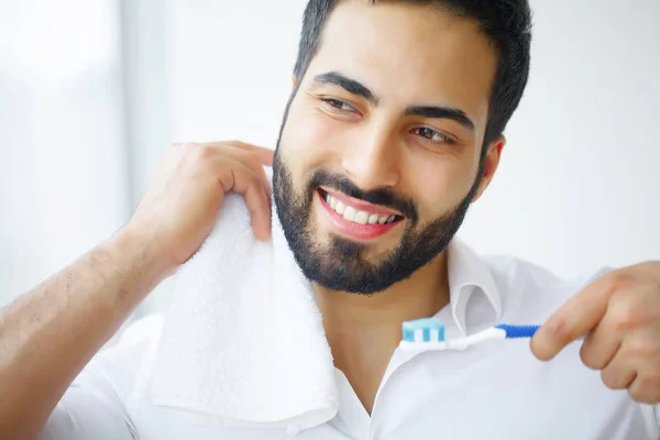 美丽的微笑的人刷健康的白色牙齿。H — 图库照片