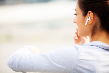 Fitness. Güzel kadın su içme ve koştuktan sonra müzik dinlemek