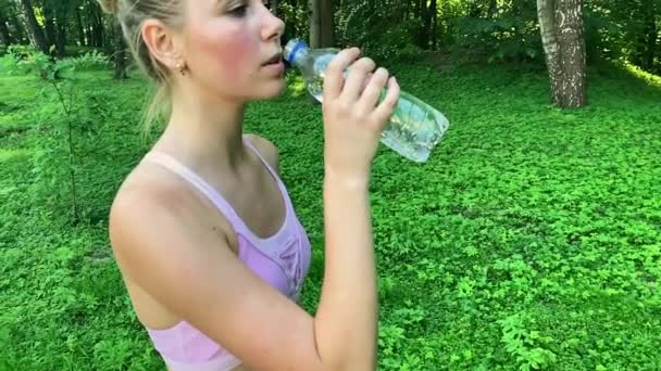 Fitness outdoor. Woman drinking bottle of water — Stock Video