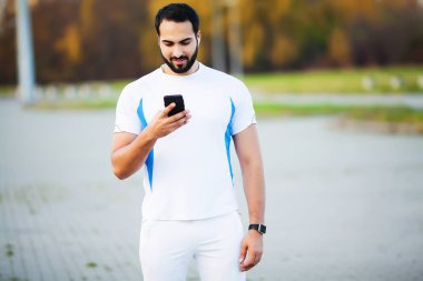 Fit muscular man running outside. Fitness and sport concept