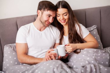 Intimate sensual young couple in bedroom enjoying each other
