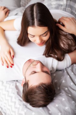 Intimate sensual young couple in bedroom enjoying each other