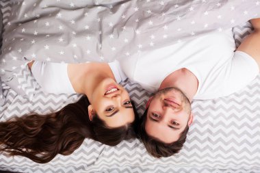 Intimate sensual young couple in bedroom enjoying each other