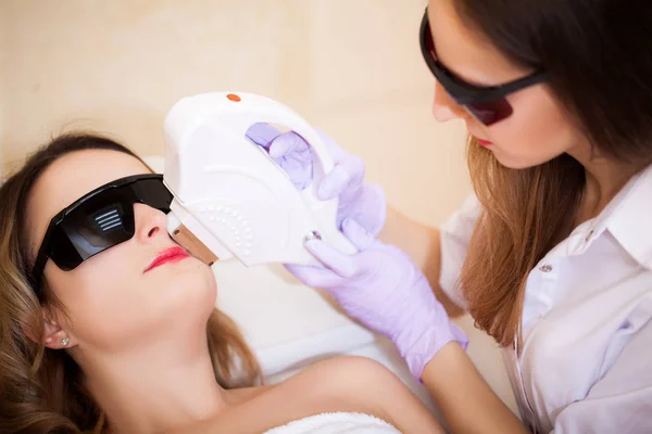 Woman receiving laser epilation treatment on her face — Stock Photo, Image