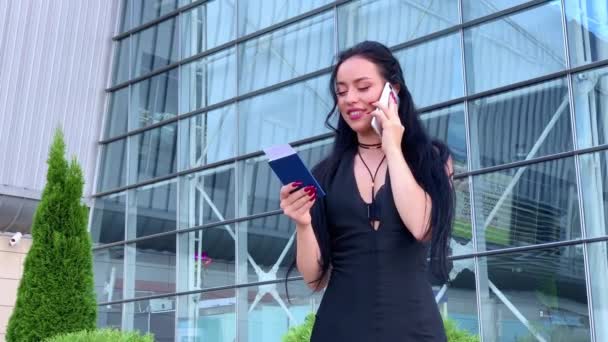 Vacaciones. Sonriente pasajera procediendo a la puerta de salida tirando de la maleta a través del vestíbulo del aeropuerto — Vídeos de Stock