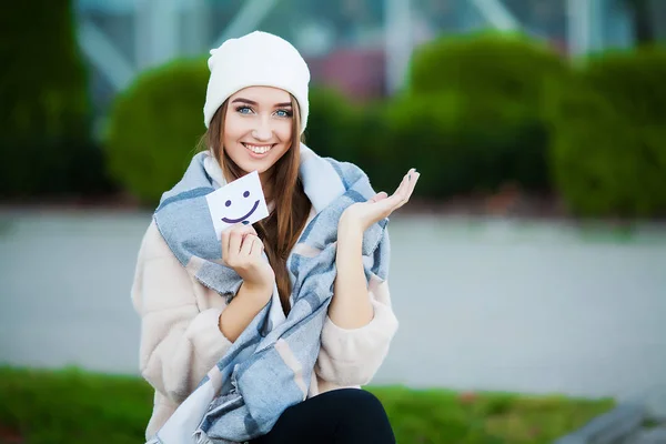 Beautiful woman holding cards with funny smile — Stock Photo, Image