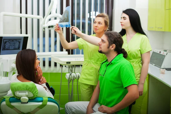 Pretty woman visiting her dentist in clinic — Stock Photo, Image