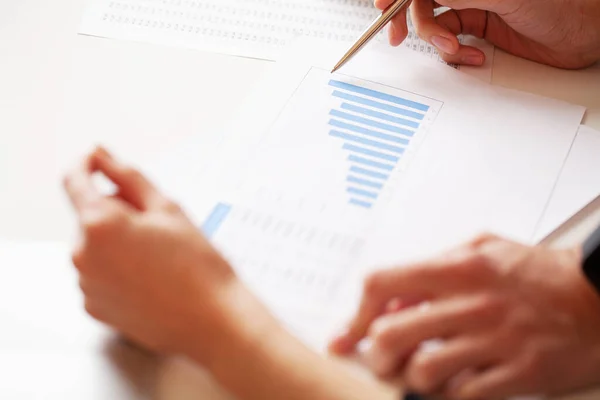 Businessman sitting at office desk signing a contract — Stock Photo, Image