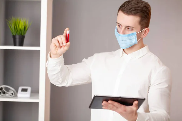 Young doctor holding test tubes with virus tests. — Stock Photo, Image