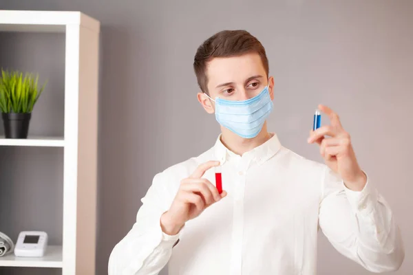 Young doctor holding test tubes with virus tests. — Stock Photo, Image