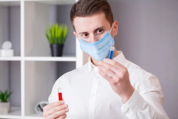 Young doctor holding test tubes with virus tests. — Stock Photo, Image