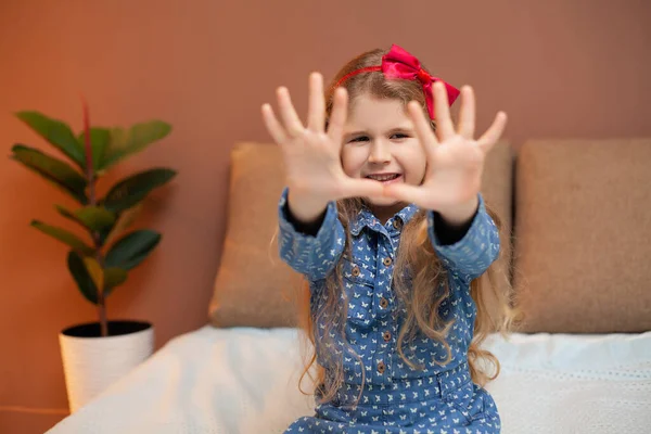 Klein meisje rustend op het bed in de kamer — Stockfoto