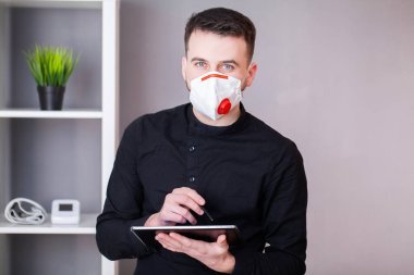 Koronavirüsten korunmak için maske takıyor.