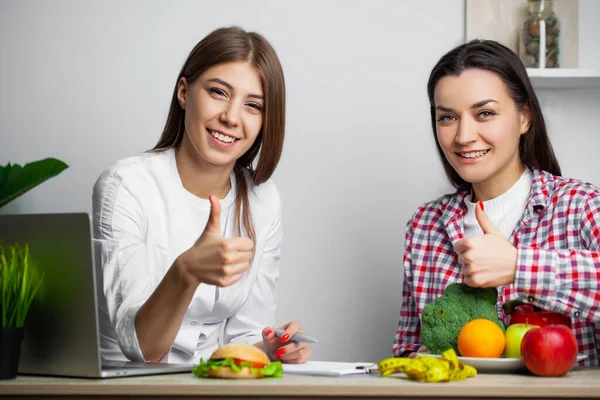 Woman makes a choice between healthy and harmful food — Stock Photo, Image