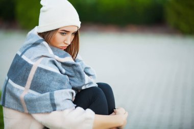 Sokaktaki hasta kadın soğuk algınlığı virüsü belirtileri gösteriyor.