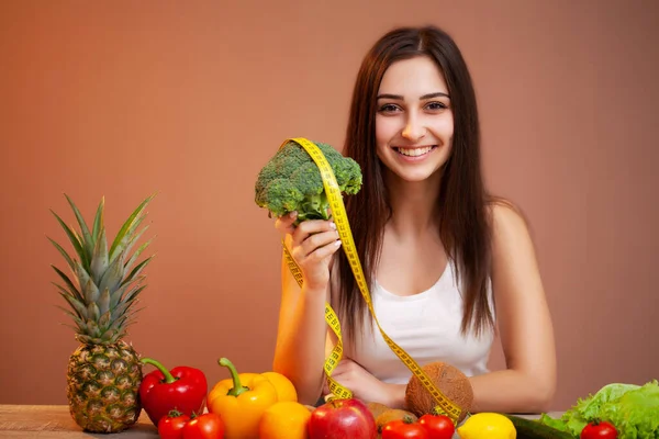 Retrato de una joven hermosa mujer con verduras, frutas y cinta métrica — Foto de Stock
