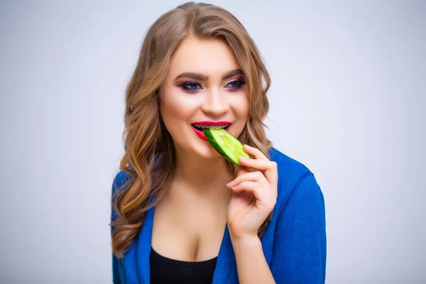 Cute woman eating green cucumber with lots of vitamins — Stock Photo, Image