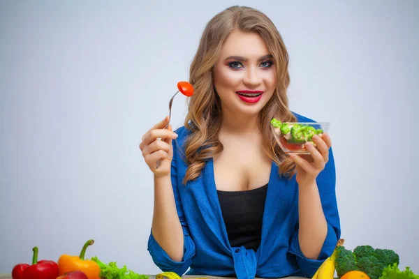 かわいい女性はビタミンの多くと野菜サラダを食べる — ストック写真