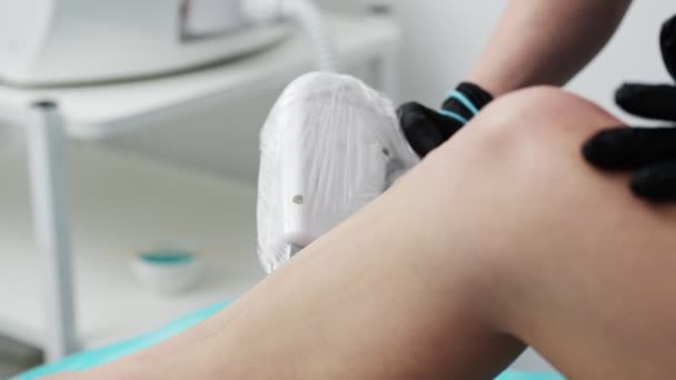 若い女性は美容室で足のためのレーザー脱毛を受けます — ストック動画