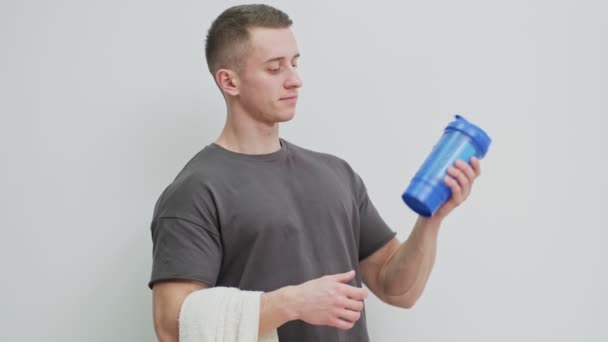 Athletic man prepares protein shake after workout. — Stock Video