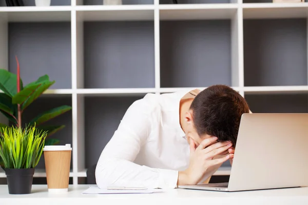 Tired man working at company office at computer — Stock Photo, Image