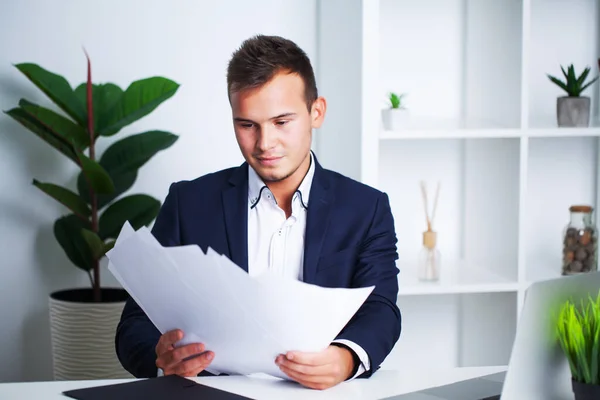 Solid businessman in a jacket works with documents in office of the company. — Stock Photo, Image