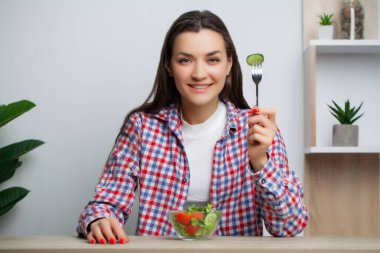 Tatlı kadın bir sürü vitaminli sebze salatası yiyor..