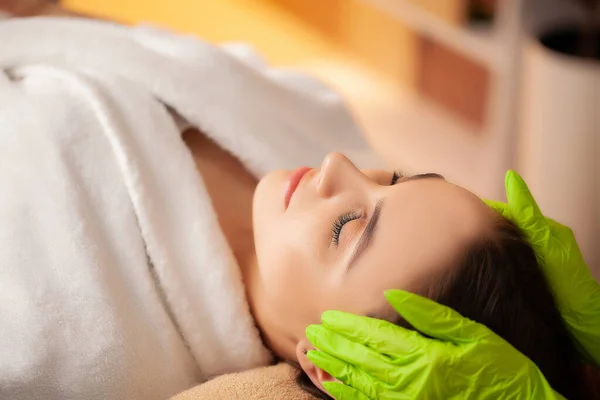 Pretty woman receiving facial massage in spa salon — Stock Photo, Image