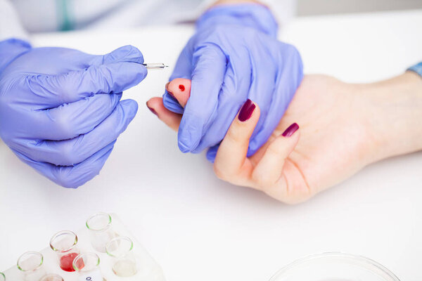 Woman at the hospital submits a blood test for a coronavirus