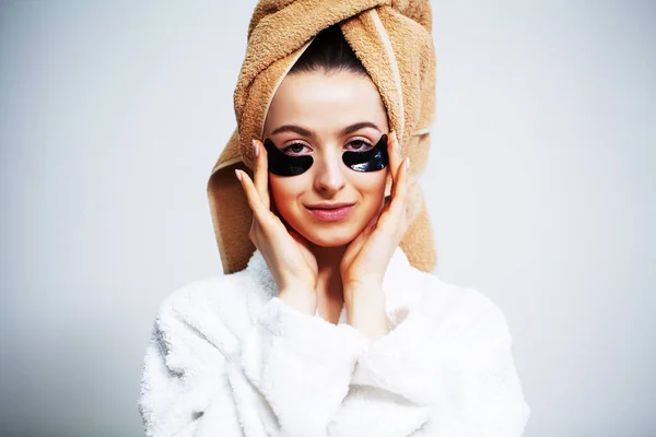 Cute woman in bathroom use patches for facial skin care. — Stock Photo, Image