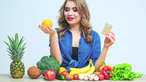 Giovane donna su una dieta rigorosa sullo sfondo di verdure fresche e frutta — Video Stock