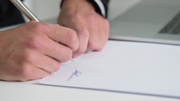 Young man works with documents in the office and signs a contract — Stock Video