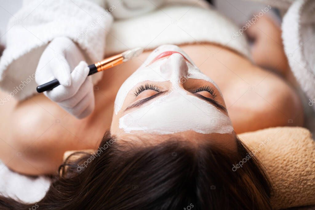Pretty woman relaxes during spa treatments at beauty salon