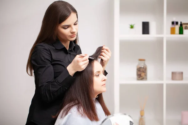 Professional hairdresser does hair care procedures at home — Stock Photo, Image