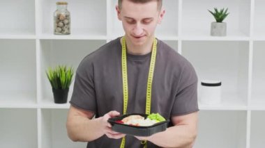 Sağlıklı beslenme kavramı, atletik yapılı bir adam kilo vermek için düzgün yemek yer.