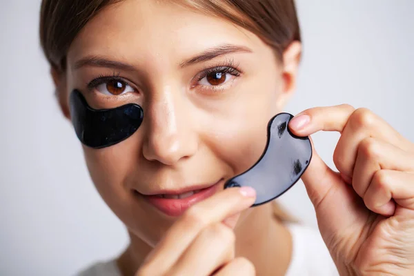 Eye patch, Beautiful Woman With Natural Makeup And Black Hydro Gel Eye Patches On Facial Skin